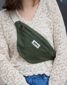 a woman holding a cell phone in her pocket 