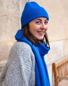 a woman wearing a blue hat and a hat 