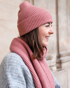 a woman wearing a pink hat and a hat 