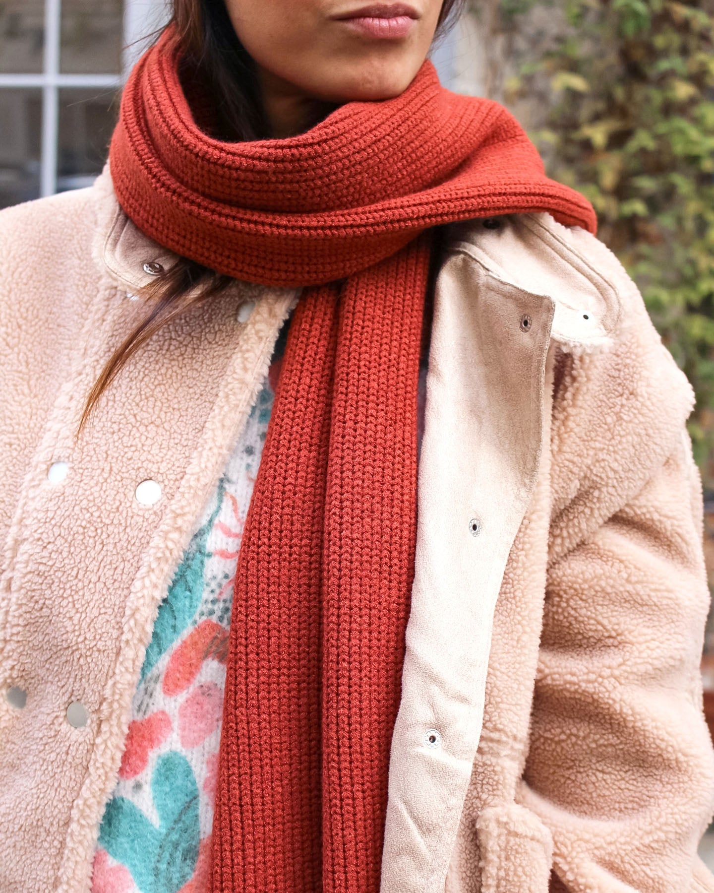 a woman wearing a red coat and hat 