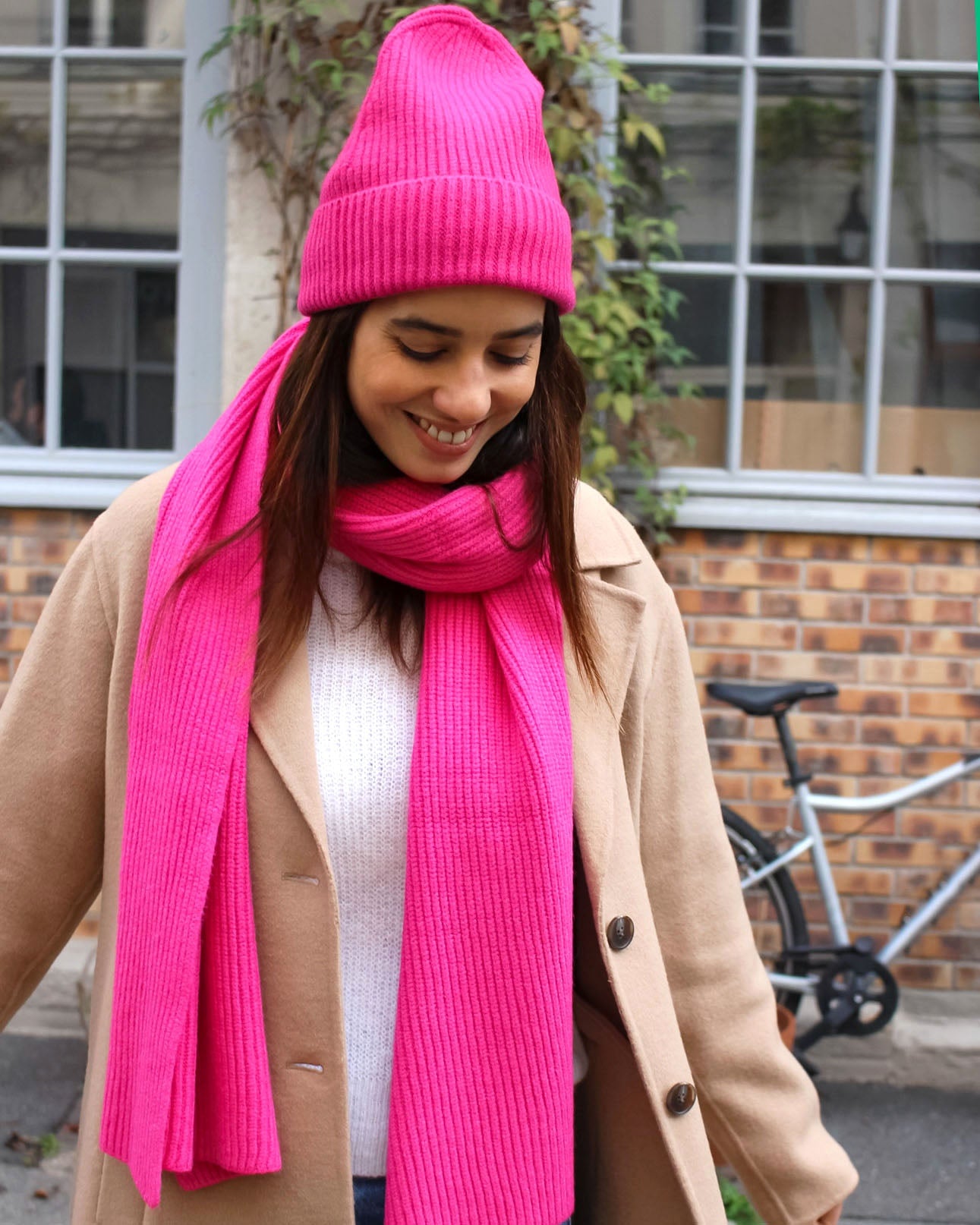 a woman wearing a pink hat and a pink dress 