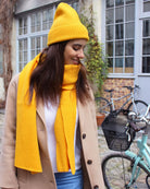 a woman in a yellow hat talking on a cell phone 